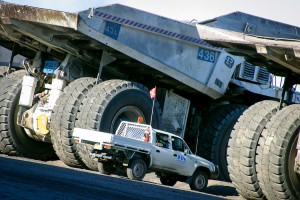 Huge Trucks Toyota Land cruiser next to 100 tonne open cut mining trucks. Mowlem Power & Mining