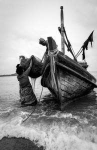 Loading Nets A woman loads nets onto a fishing boat on Koh Samui, Thailand