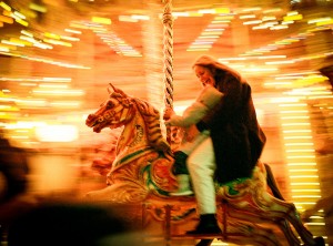 Merry-go-round A magic moment between a mother and her baby on the merry-go-round. Loughborough UK.