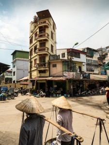 Old Quarter Hanoi Street traders carrying their wares in the streets of the Old Quarter, Hanoi, Vietnam