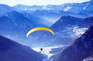 Paraglider Paraglider takes off from the ski resort of Verbier in the Swiss Alps.