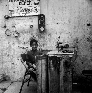 Reper Boy This boy has his business on a street in New Delhi, India. His service offers the "reper" of speedometers. I found the hand drill fastened to the bench amusing. I am quite sure it wasn't there to wind the odometers forward.