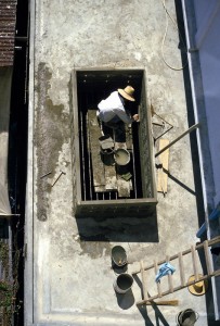 Thai Builder Builder rendering a wall in Bangkok, Thailand.