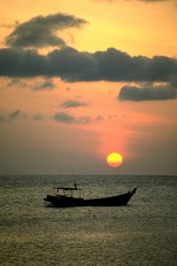 Thai Sunset Boat Fishing Boat off the shore of Koh Phangan, Thailand. A couple of years after I took this photo in 1986, Thailand was voted international tourist destination of the year. The Thai tourist logo had a sun that looked just like this one so I was pleased I got the image while I was travelling there.