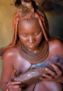 Burning Incense A Ovahimba woman burns incense. In himba tradition the women never use water to clean themselves. Their skin is coloured with red clay and they use the smoke of selected plants and bark to "cleanse" themselves.